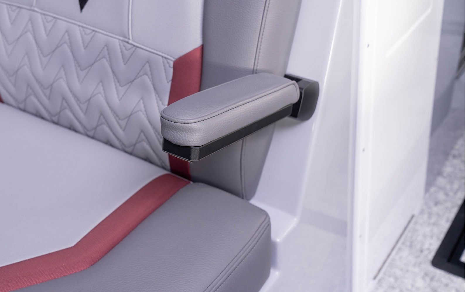 Interior view of a boat's back seat, equipped with speakers and ambient lighting for a lively atmosphere.