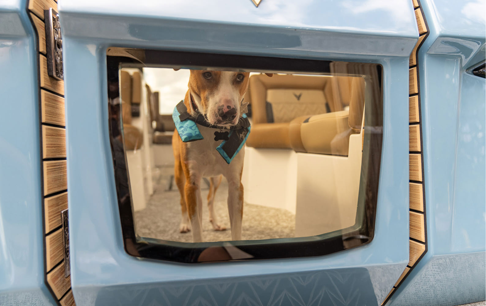 A man and woman sit on a boat while a girl joyfully jumps in the air beside them, capturing a moment of fun on the water.
